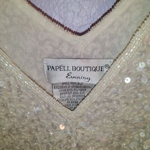 Medium shirt, creme colored with sequins and shoulder opening.
